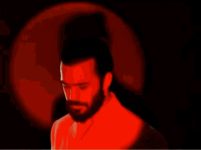 a man with a beard is wearing a yellow robe