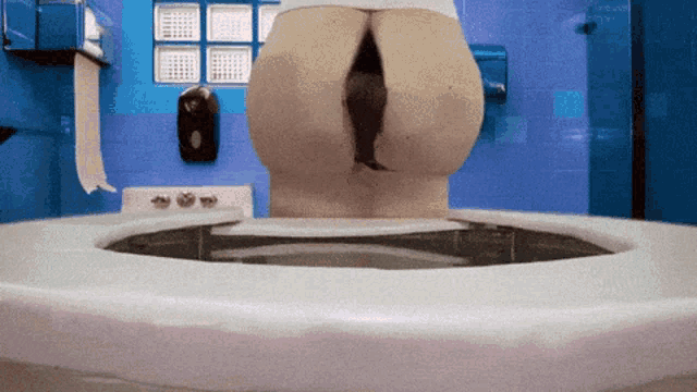 a woman 's butt is visible in a bathroom sink