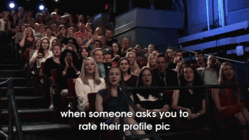a crowd of people sitting in a theater with the words when someone asks you to rate their profile pic