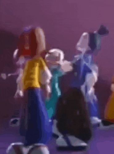 a group of cartoon characters are standing next to each other on a purple surface .