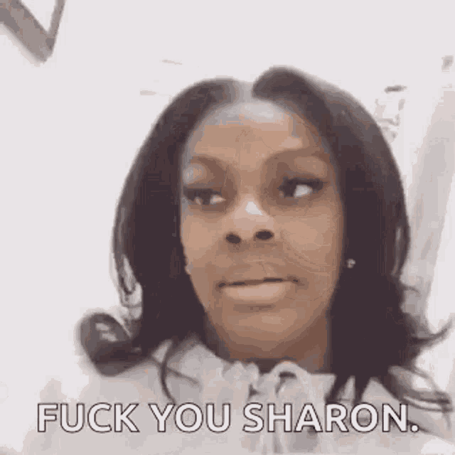 a woman is making a funny face and saying `` fuck you sharon . ''