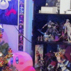 a blurred image of a room with a shelf full of figurines and a christmas tree