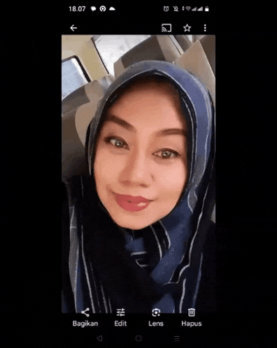 a painting of a woman wearing a hijab with a blue background