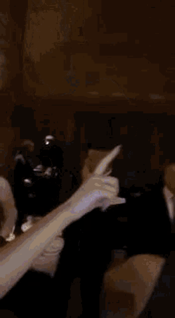 a man in a suit and tie is dancing in a room in a blurry photo .