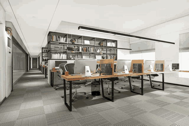 an office with a lot of desks and chairs and computers on them