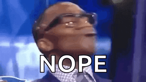a man wearing glasses and a suit is making a funny face with the word nope behind him .