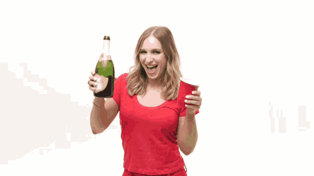 a woman in a red shirt is holding a bottle of wine and a red cup