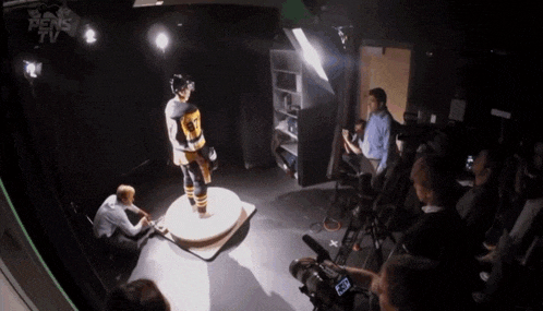 a hockey player with the number 7 on his jersey is being photographed