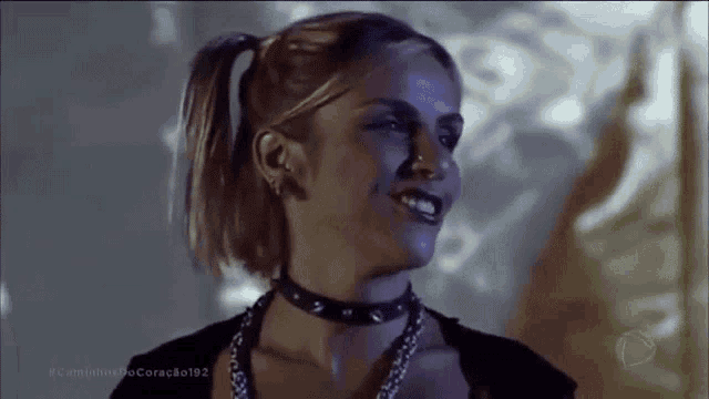 a woman with pigtails is wearing a choker and a necklace .