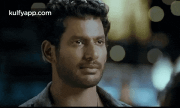 a close up of a man 's face with a beard in a movie .