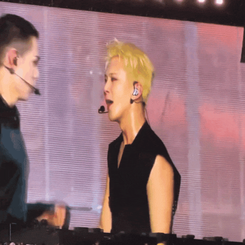 a man wearing a headset is dancing with another man