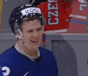 a hockey player is wearing a helmet with the word iloq on it