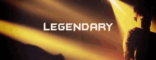a man stands in front of a spotlight with the word legendary on the bottom