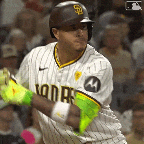 a baseball player wearing a padres jersey is swinging at a ball