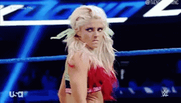 a woman is standing in a wrestling ring with a usa logo in the background