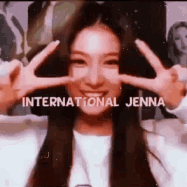 a young woman is making a peace sign with her hands .