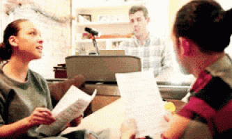 a group of people sitting around a table with papers in front of them