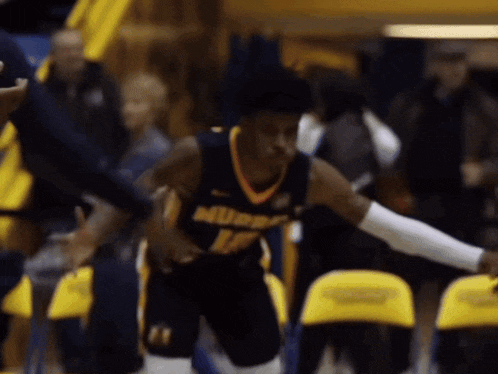 a blurred image of a basketball player wearing a jersey that says murphy