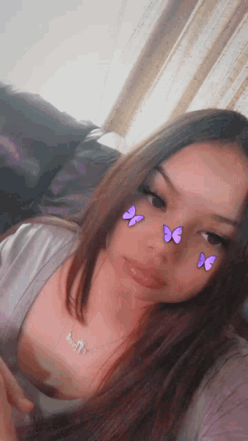 a woman with purple butterflies on her face is sitting on a couch