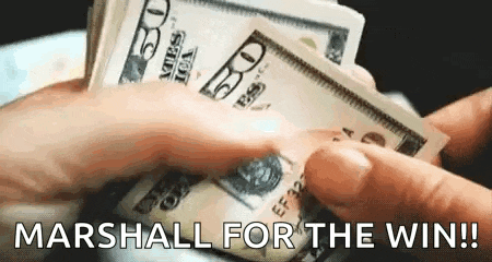a person is holding a stack of money in their hands and says `` marshal for the win '' .