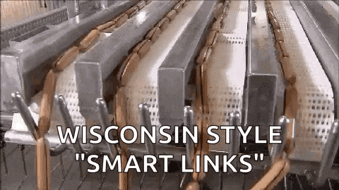 wisconsin style smart links sausages are being made on a conveyor belt .