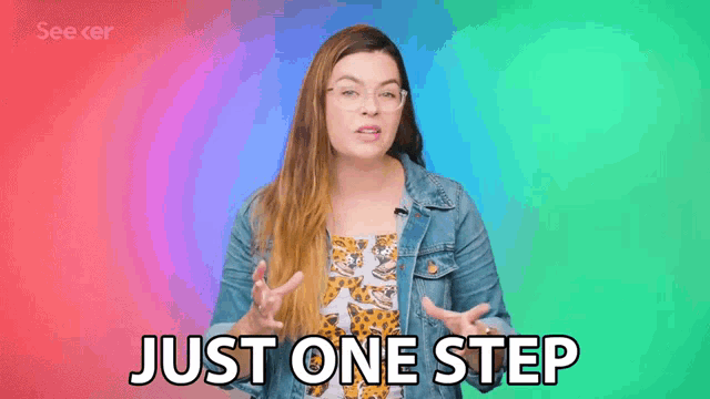 a woman in a denim jacket and leopard print top is making a funny face and saying just one step .