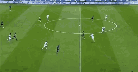 a group of soccer players are playing on a field with advertisements for inter tv