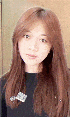 a close up of a woman 's face with a picture of a camera on her shoulder
