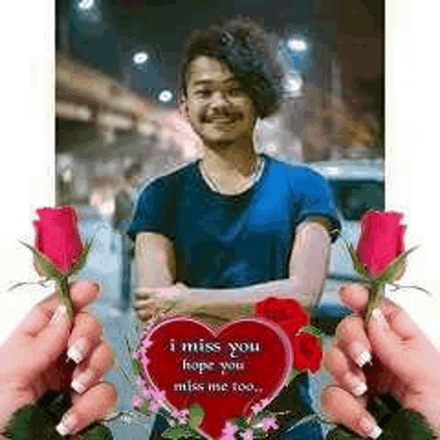 a man is holding roses and a heart with the words `` i miss you hope you miss me too '' written on it .