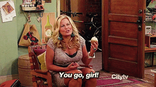 a woman is sitting in a chair holding an ice cream cone and saying you go girl on citytv