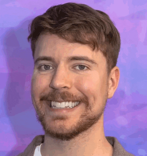 a man with a beard is smiling and looking at the camera .