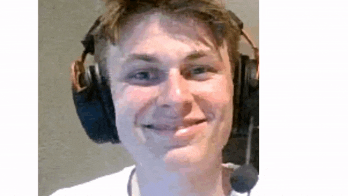 a close up of a man wearing headphones and a microphone .