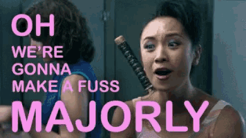 a woman is holding a sword with the words oh we 're gonna make a fuss majorly above her