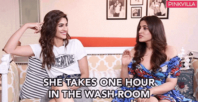 two women are sitting on a couch with the words she takes one hour in the wash room on the bottom
