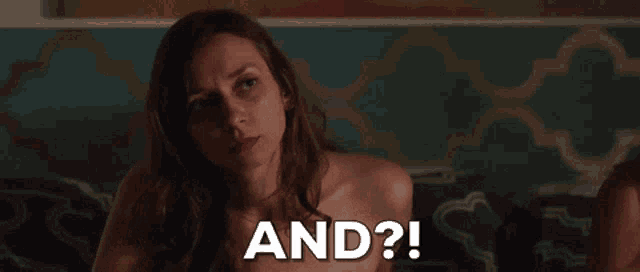 a woman without a shirt is sitting on a couch and the words and are visible