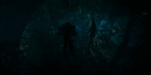 a group of people are swimming in a dark ocean