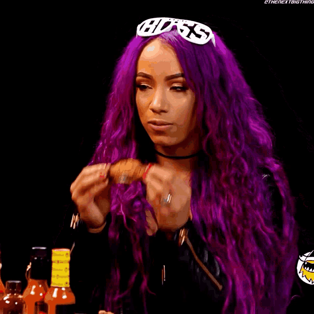 a woman with purple hair wearing a headband with the word boss on it