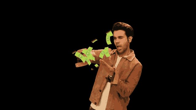 a man in a brown jacket is standing in front of a pile of money