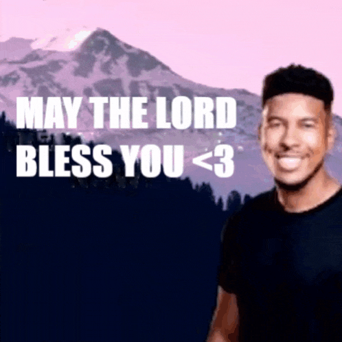 a man with a mountain in the background is smiling and says may the lord bless you < 3