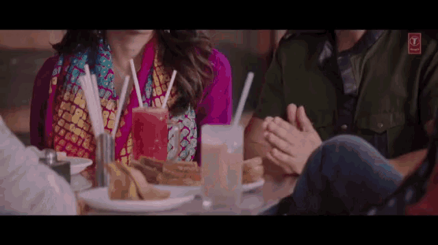 a group of people sitting at a table with drinks