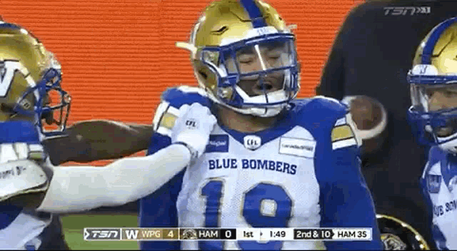 a football player wearing a blue and gold uniform with the number 10 on it .