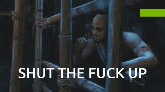 a man in a cage with the words shut the fuck up on the bottom