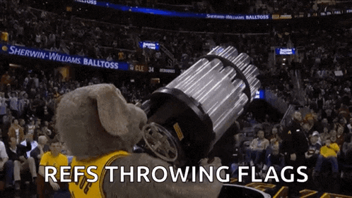 a mascot is throwing flags in front of a crowd with the words refs throwing flags below it