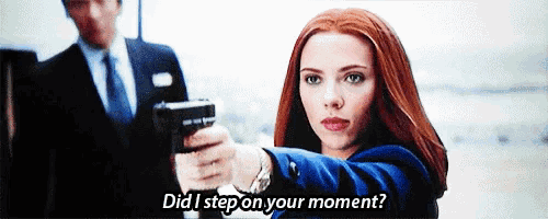 a woman is pointing a gun at a man in a suit and tie and says `` did i step on your moment ? ''