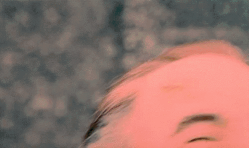 a close up of a person 's face with their eyes closed