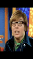 a close up of a man wearing glasses and a green tie making a funny face .