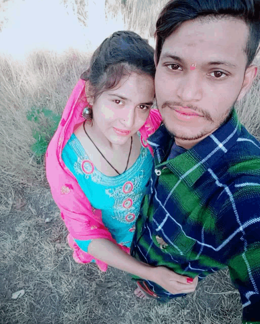 a man and a woman are posing for a picture