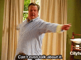 a man is standing in front of a window with his arms outstretched and saying " can 't even talk about it "