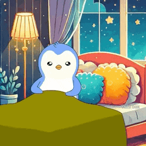 a penguin is sitting on a bed with a green blanket .
