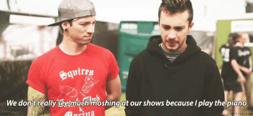 two men are standing next to each other and one of them is wearing a red shirt that says squirrels on it